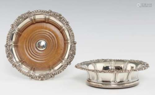 A PAIR OF VICTORIAN GADROONED SILVER WINE COASTERS the rim with shells and scrolling foliage at