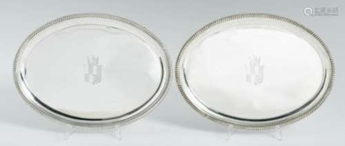 A PAIR OF GEORGE III OVAL SILVER WAITERS moulded cavetto and gadrooned rim, on four conforming feet,