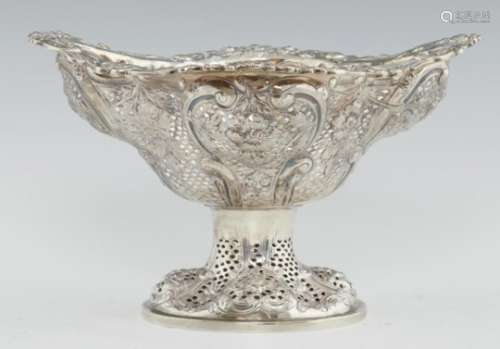 A VICTORIAN PIERCED AND EMBOSSED SILVER FRUIT BOWL on oval foot, 19.5cm h, by Charles Stuart Harris,