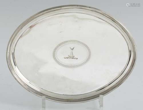 A GEORGE III OVAL SILVER SALVER on four reeded feet, crested, 23cm l, by George Smith II and