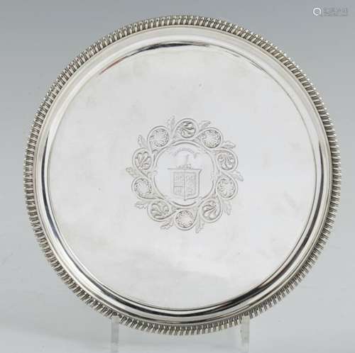 A GEORGE III GADROONED SILVER SALVER OF HEAVY GAUGE engraved with armorials in flat chased