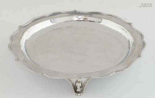 AN ARTS & CRAFTS SILVER WAITER BY THE GUILD OF HANDICRAFT with beaded rim and feet, 20.5cm diam,