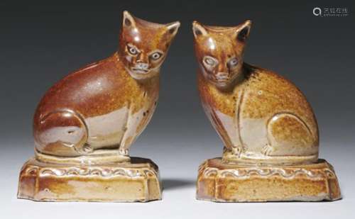 A PAIR OF ENGLISH SALTGLAZED BROWN STONEWARE MODELS OF CATS, C1820 8cm h++One with minor chips under