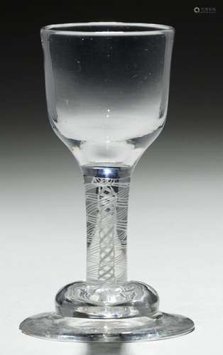 AN ENGLISH DRAM GLASS, C1760 the ogee bowl on double series opaque twist stem and domed foot, 11cm