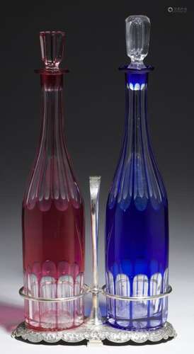 A PAIR OF VICTORIAN BLUE OR CRANBERRY FLASHED AND FLUTE CUT GLASS DECANTERS AND STOPPER AND A