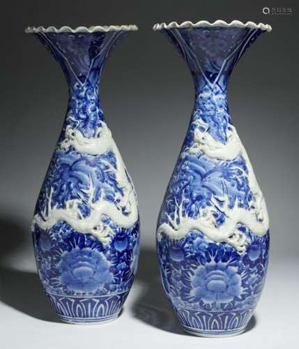 A PAIR OF JAPANESE IMARI BLUE AND WHITE DRAGON VASES, MEIJI PERIOD 61cm h++Wave neck of one vase