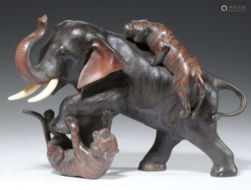 A JAPANESE BRONZE SCULPTURE OF AN ELEPHANT ATTACKED BY TIGERS, MEIJI PERIOD ivory tusks, brown,