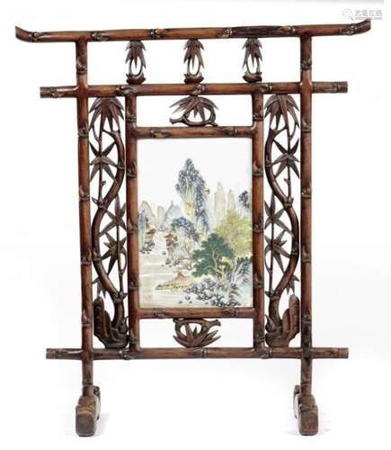 A CHINESE PORCELAIN SCREEN TILE, QING DYNASTY, C1900 painted with a seated figure in a mountainous