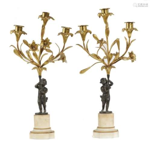 A PAIR OF FRENCH BRONZE AND ORMOLU CANDELABRA, C1900 in the form of amorini, on beaded marble