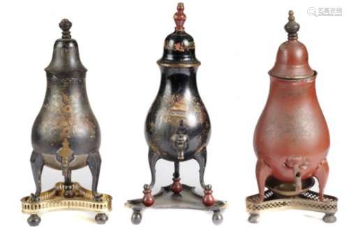 THREE CONTINENTAL JAPANNED BALUSTER COFFEE URNS AND COVERS, EARLY 19TH C on three scrolling legs,