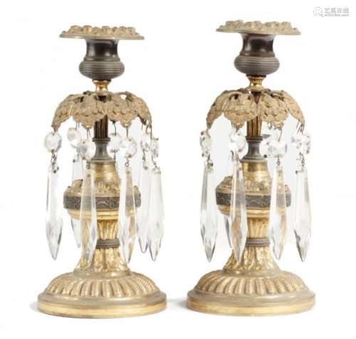 A PAIR VICTORIAN EMBOSSED GILT AND PATINATED BRASS LUSTRE CANDLESTICKS, C1840 hung with prismatic