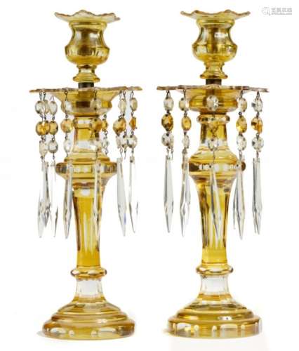 A PAIR OF AMBER FLASHED AND CUT GLASS LUSTRE CANDLESTICKS, LATE 19TH/EARLY 20TH C with prismatic cut
