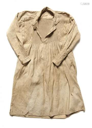 RURAL BYGONES. A BEIGE LINEN TWILL WORKING SMOCK, MID 19TH C of coat-type with smocked panel front