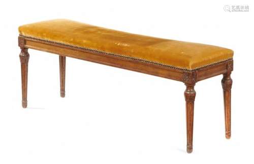 A LOUIS XVI BEECH BANQUETTE, LATE 18TH C with panelled frame raised on tapering, turned fluted