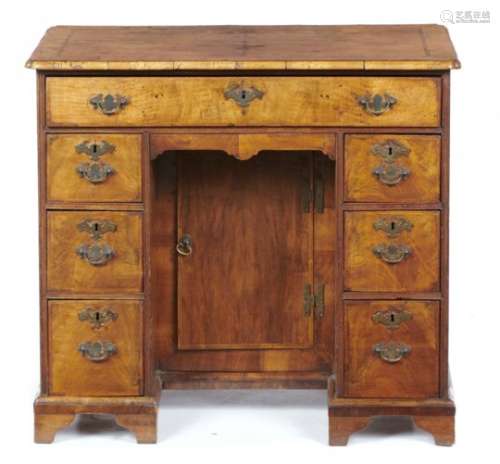 A GEORGE II WALNUT AND FEATHERBANDED KNEEHOLE DESK OR DRESSING TABLE, MID 18TH C the quarter