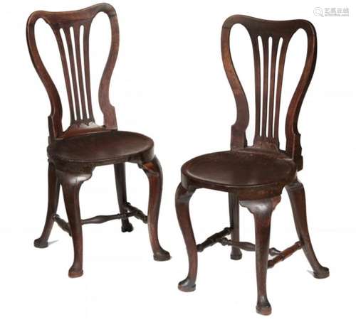 A PAIR OF GEORGE II MAHOGANY HALL CHAIRS, C1750 with spoon back and dished, almost round seat, on