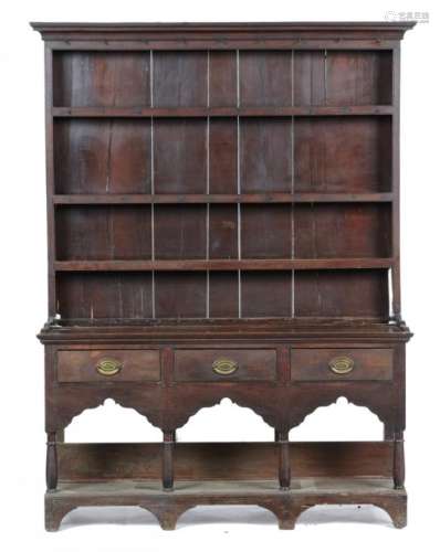 A GEORGE III OAK DRESSER with cavetto cornice to the boarded three shelf rack, the base fitted three