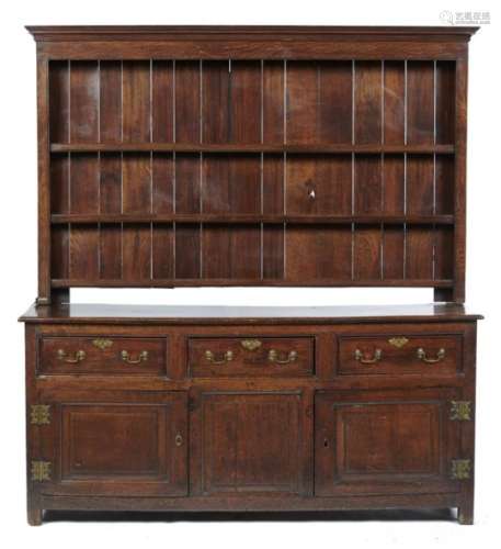 A GEORGE III OAK DRESSER, EARLY 19TH C fitted with three drawers above three doors with raised-and-