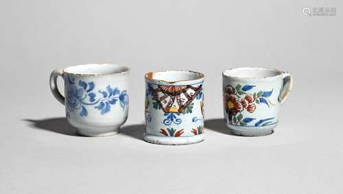 Two delftware coffee cups and a small mug or can c…