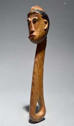 A North American club with a carved head having a …