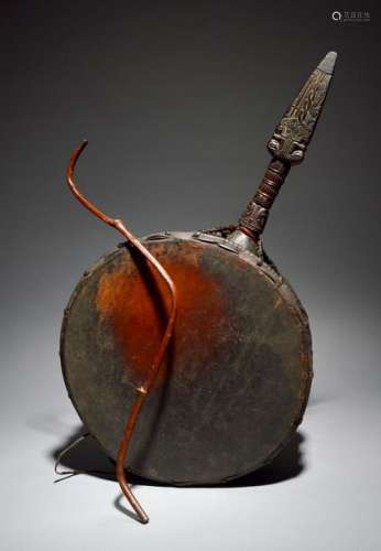 A Nepalese Shaman's drum with a carved handle, vel…
