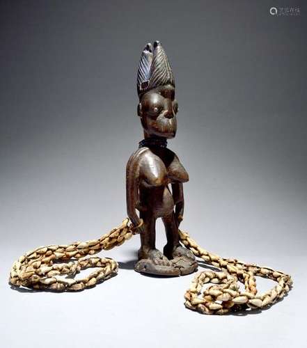 A Yoruba female Ibeji figure Nigeria with a ribbed…