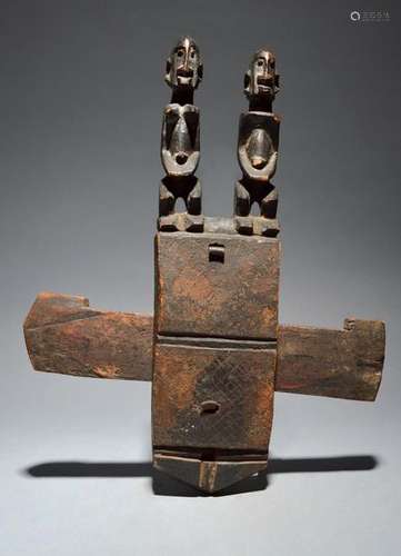 A Dogon door lock Mali with a pair of seated male …