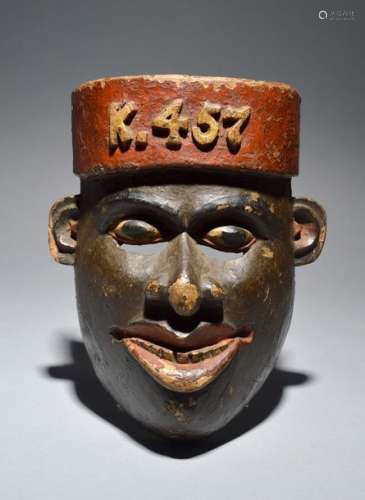 A Colonial mask East Africa wearing a fez, relief …