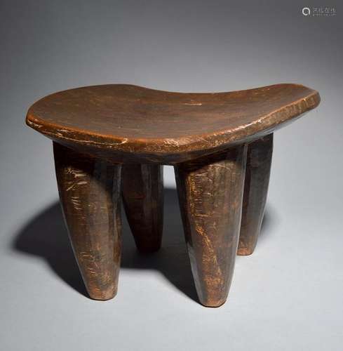 A Senufo stool Ivory Coast with a dished seat and …