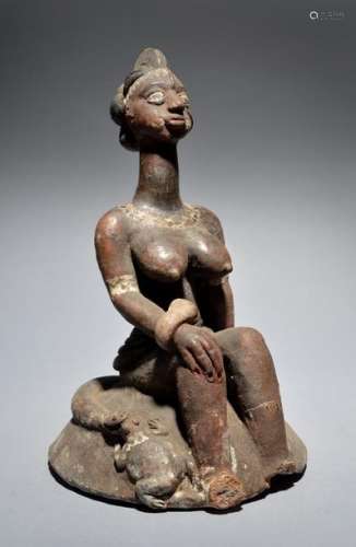 A Nigeria seated female figure attributed to Azume…