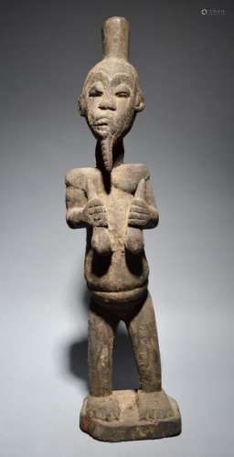 A Cameroon standing male figure with an encrusted …