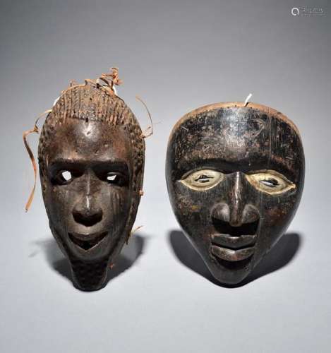 Two Yoruba masks Nigeria with a black patina and w…