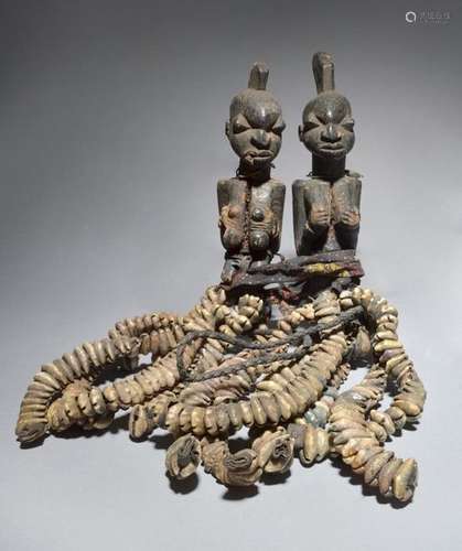 A pair of Yoruba Eshu kneeling figures Yoruba one …