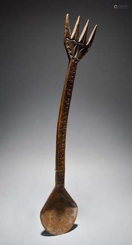 A Nigerian ladle with carved decoration and a pron…