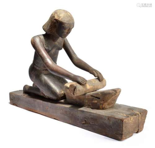 An Egyptian kneeling female figure grinding Middle…
