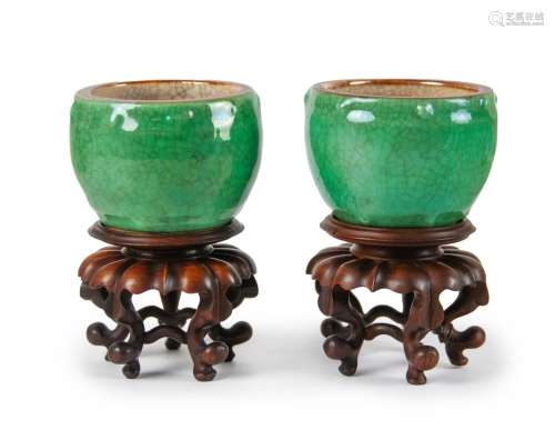 PAIR OF GREEN GLAZED RITUAL POTS ON STANDS