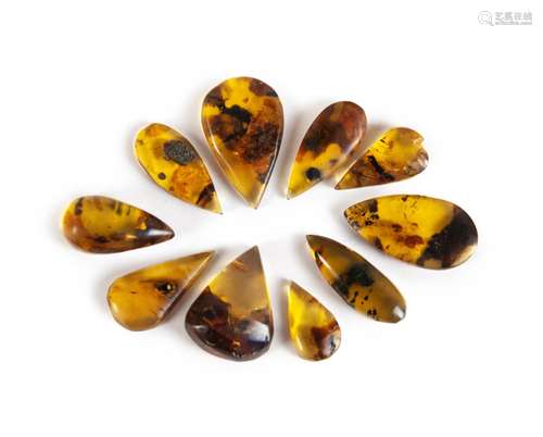 COLLECTION OF TEN BLUE-GREEN AMBER PIECES