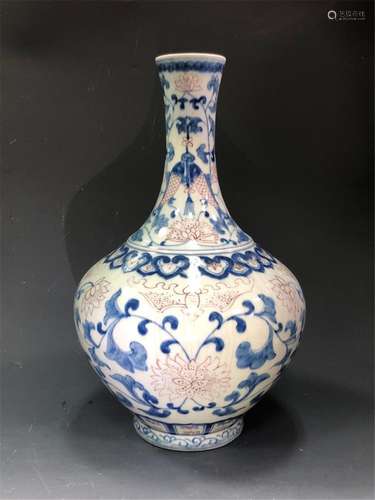 AN IRON-RED BLUE AND WHITE BOTTLE VASE.MARK OF KANGXI