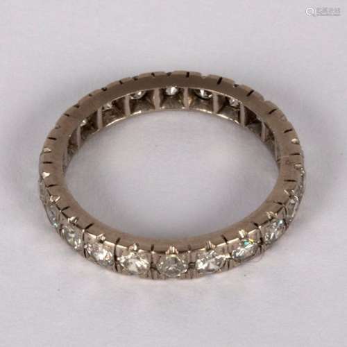 A diamond eternity ring set in white precious metal,