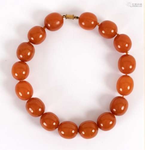 An amber necklace of large slightly oval beads,