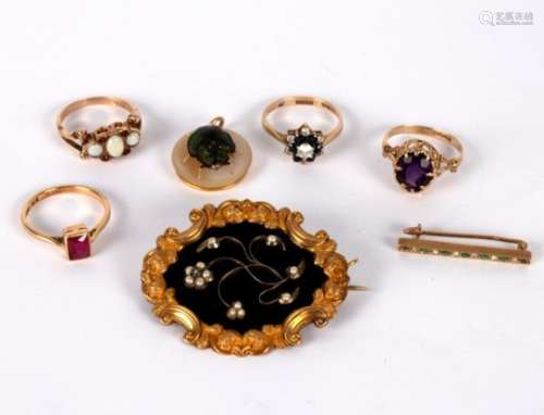 An early Victorian mourning brooch the floral motif set pearls and a small diamond to a black