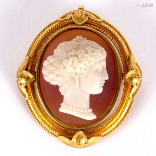 A late Victorian stone cameo brooch, the carved stone set in a 15ct yellow gold frame,