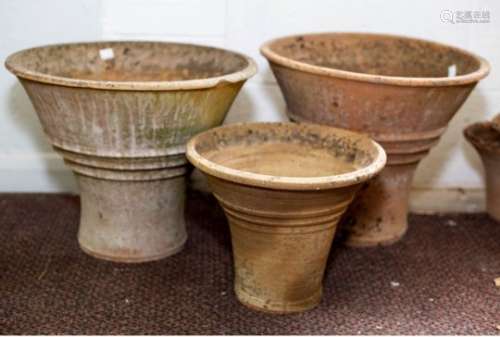 A pair of conical terracotta flower pots,