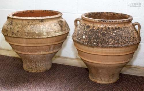 A near pair of Spanish terracotta olive jars, of bulbous form with lug handles,