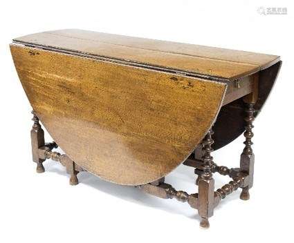 An 18th Century oak two-flap table, on bobbin turned legs and stretchers,