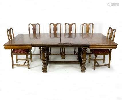 An early 20th Century extending dining table on turned supports,