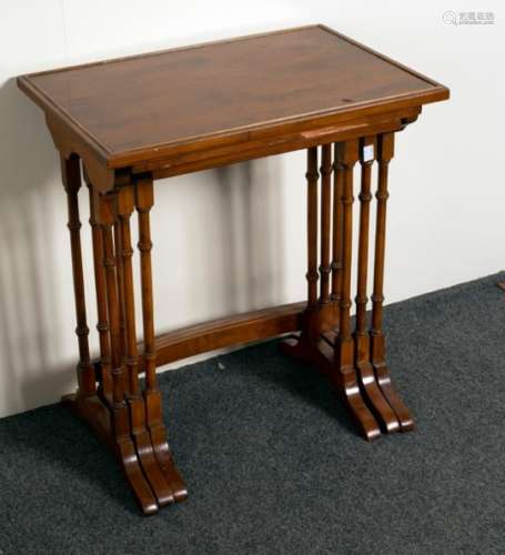 A nest of three mahogany tables on turned supports with bowed front stretcher,