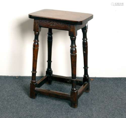 An oak stool on turned legs,