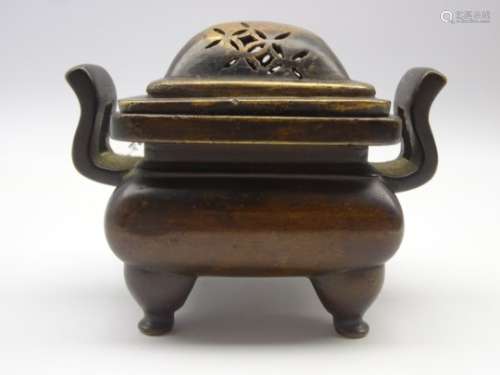 Chinese bronze censer of square form with angular handles and 4 shaped supports and associated