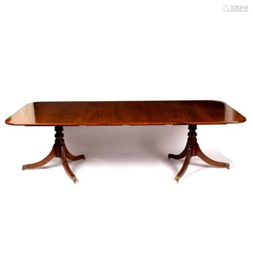 A mahogany two-pillar dining table, fitted extra leaves,